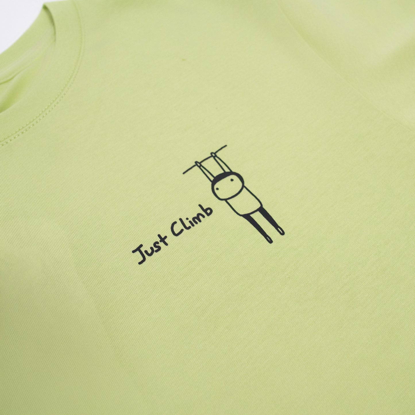 “Just Climb” graphic T-shirt featuring a cute cat and climbing elements – a fun and bold gift for rock climbers.