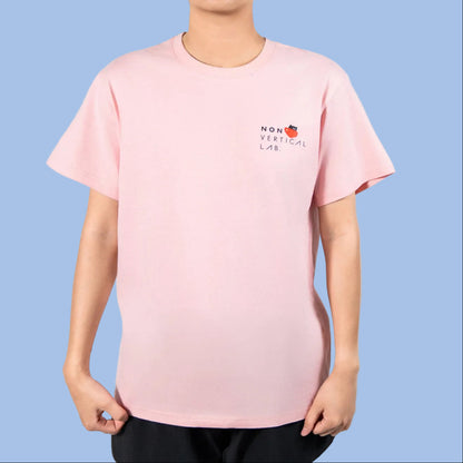 Person wearing a pink t-shirt with a Non Vertical Lab logo on a white background