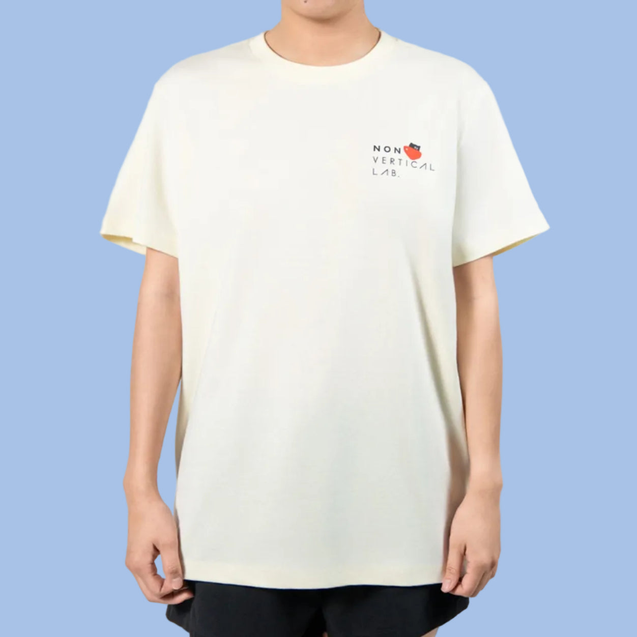 Person wearing a white t-shirt with a Non Vertical Lab logo on a plain background