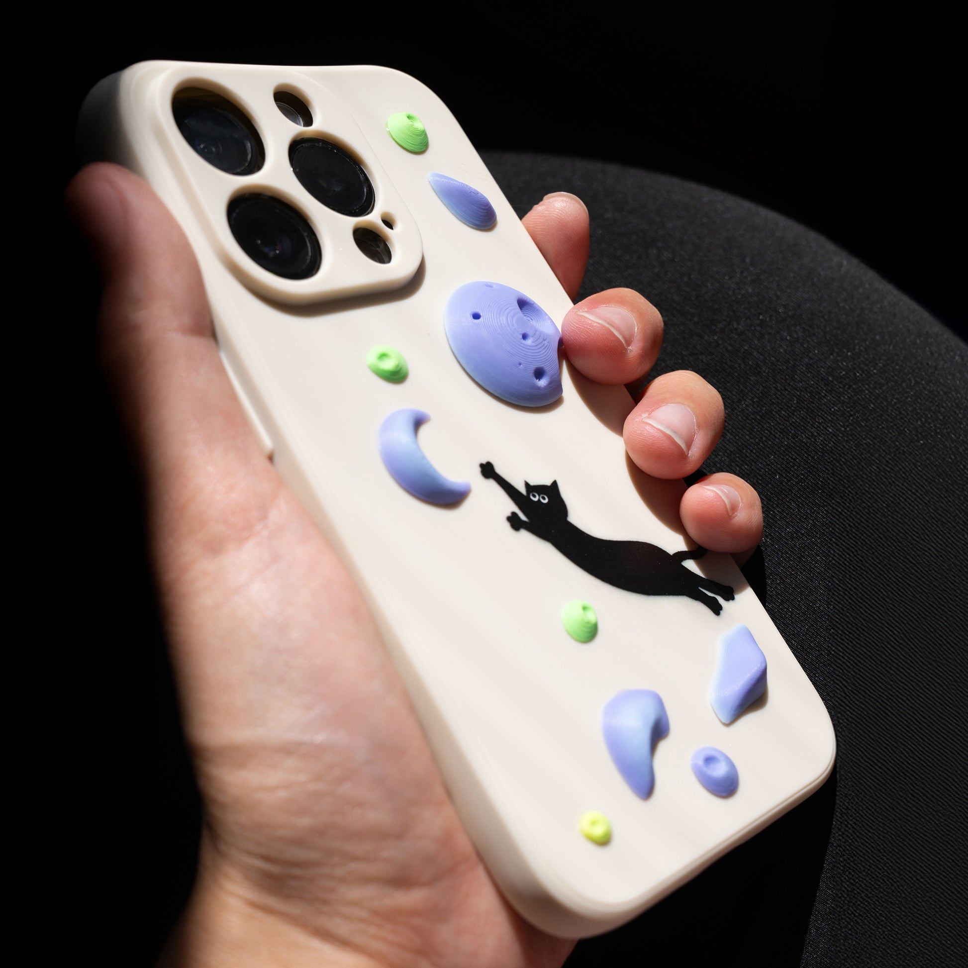A black cat mid-dyno toward colorful climbing holds – printed on a fun and bold iPhone case. A great gift for climbers and cat lovers.