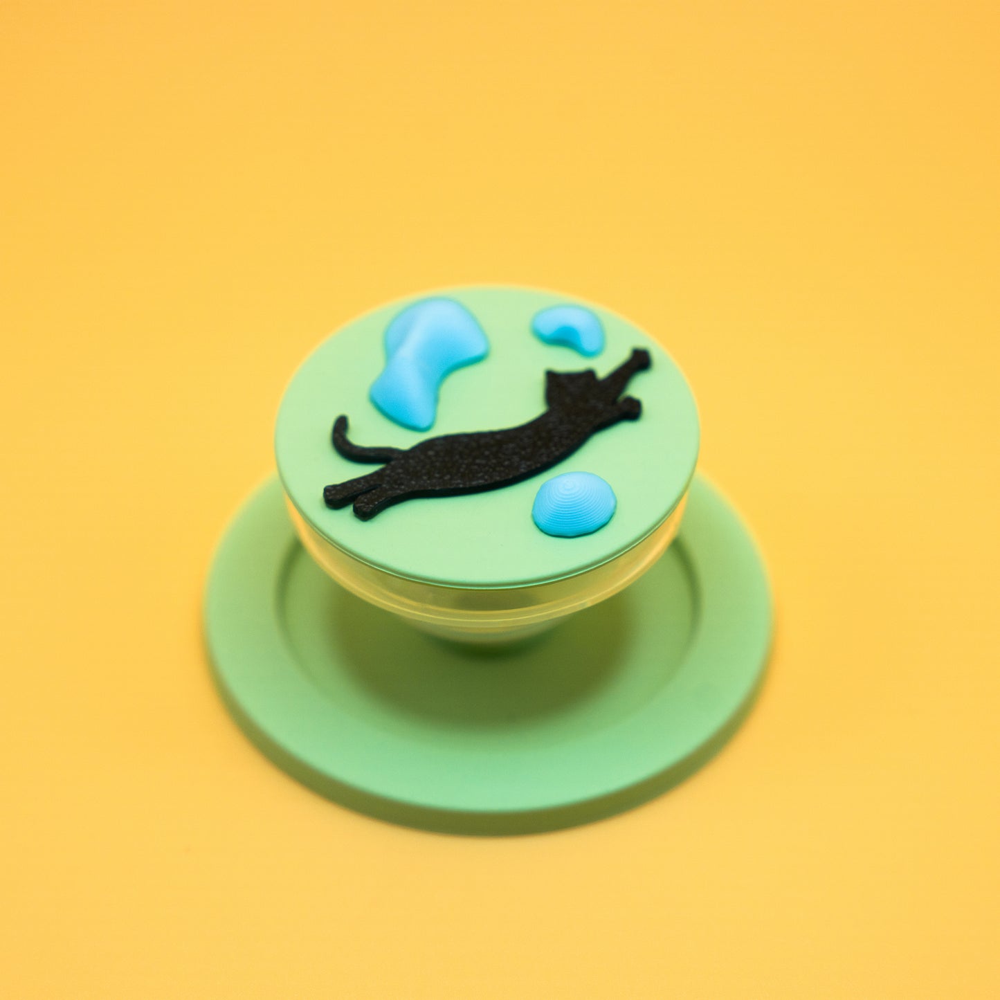 A black cat in mid-air dyno motion, leaping toward climbing holds – printed on a MagSafe phone grip. A bold gift for climbers and cat lovers. Designed by Non Vertical Lab.