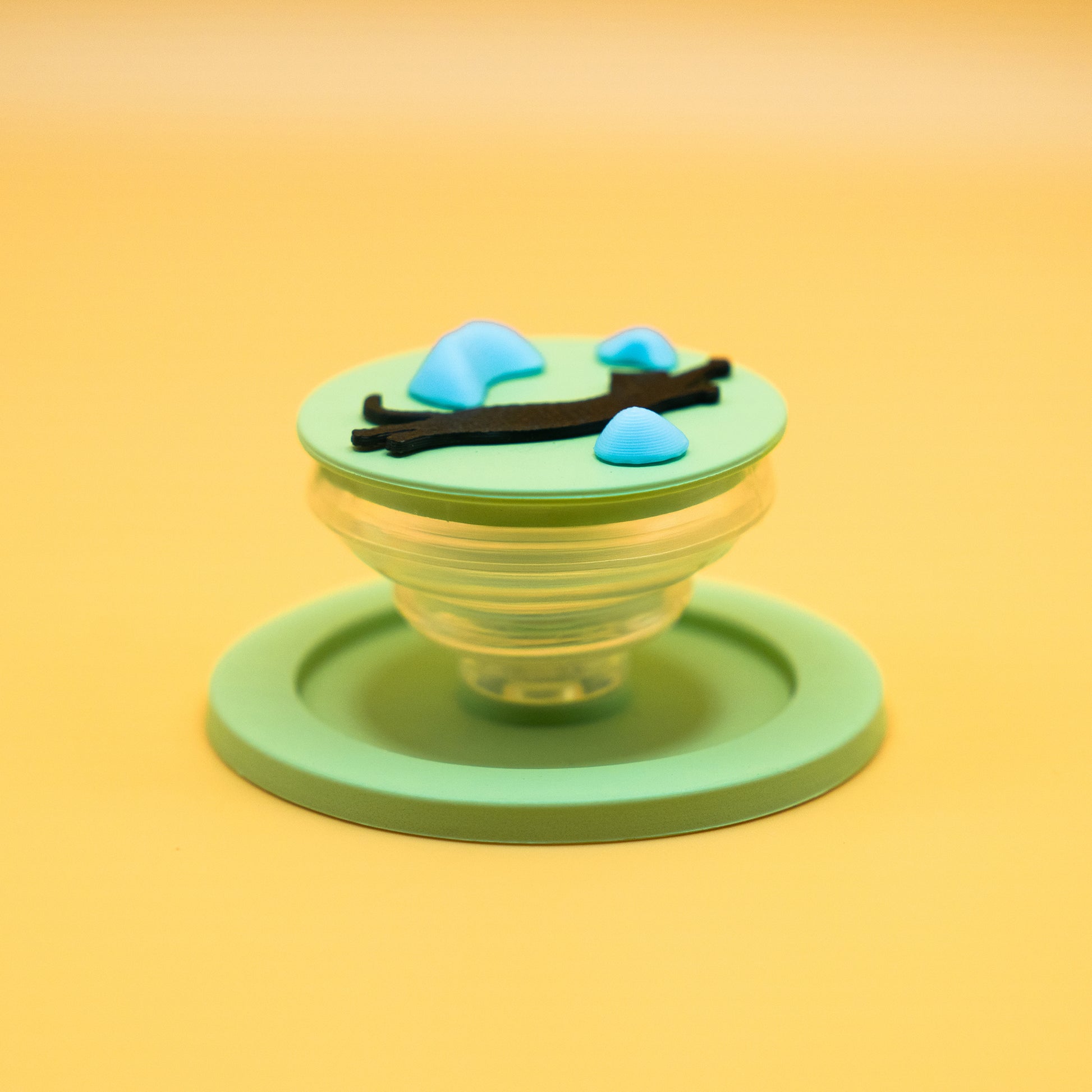 A black cat in mid-air dyno motion, leaping toward climbing holds – printed on a MagSafe phone grip. A bold gift for climbers and cat lovers. Designed by Non Vertical Lab.
