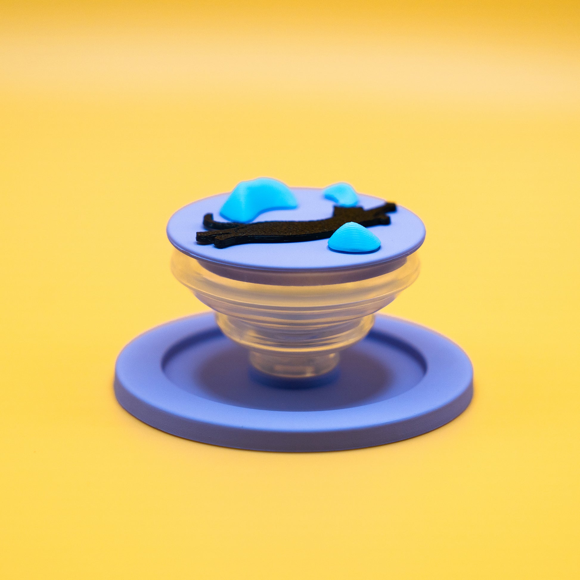A black cat in mid-air dyno motion, leaping toward climbing holds – printed on a MagSafe phone grip. A bold gift for climbers and cat lovers. Designed by Non Vertical Lab.