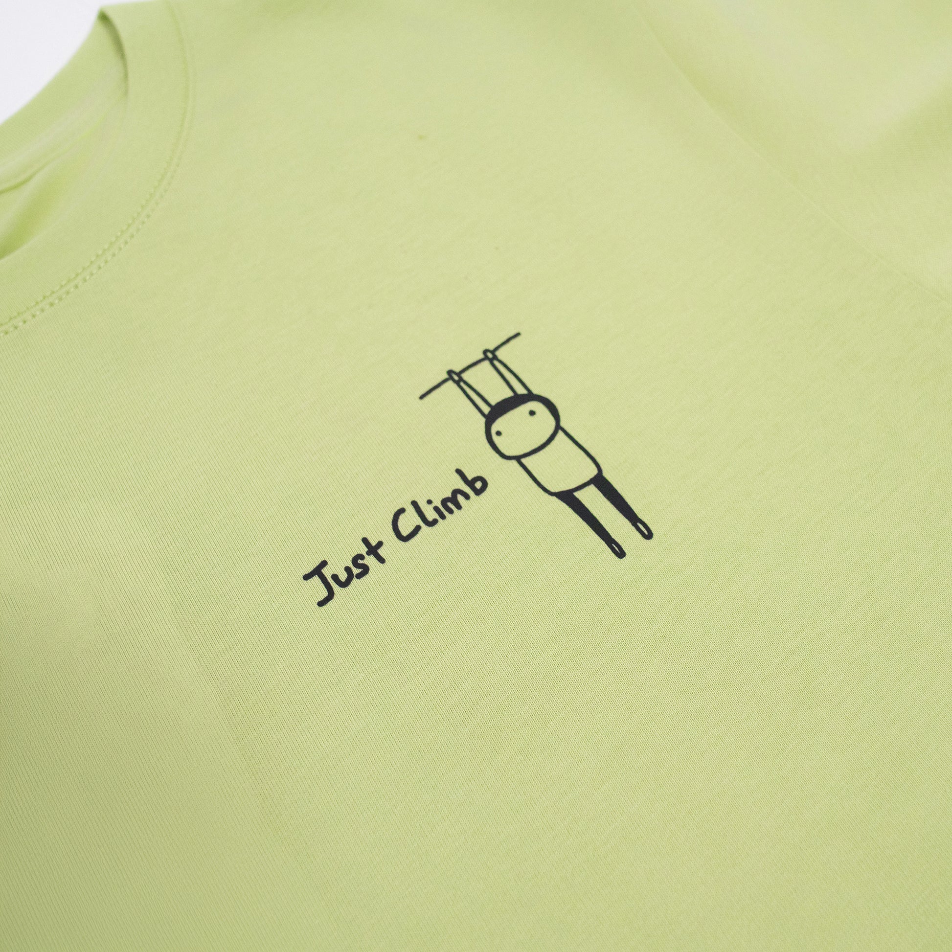 “Just Climb” graphic T-shirt featuring a cute cat and climbing elements – a fun and bold gift for rock climbers.