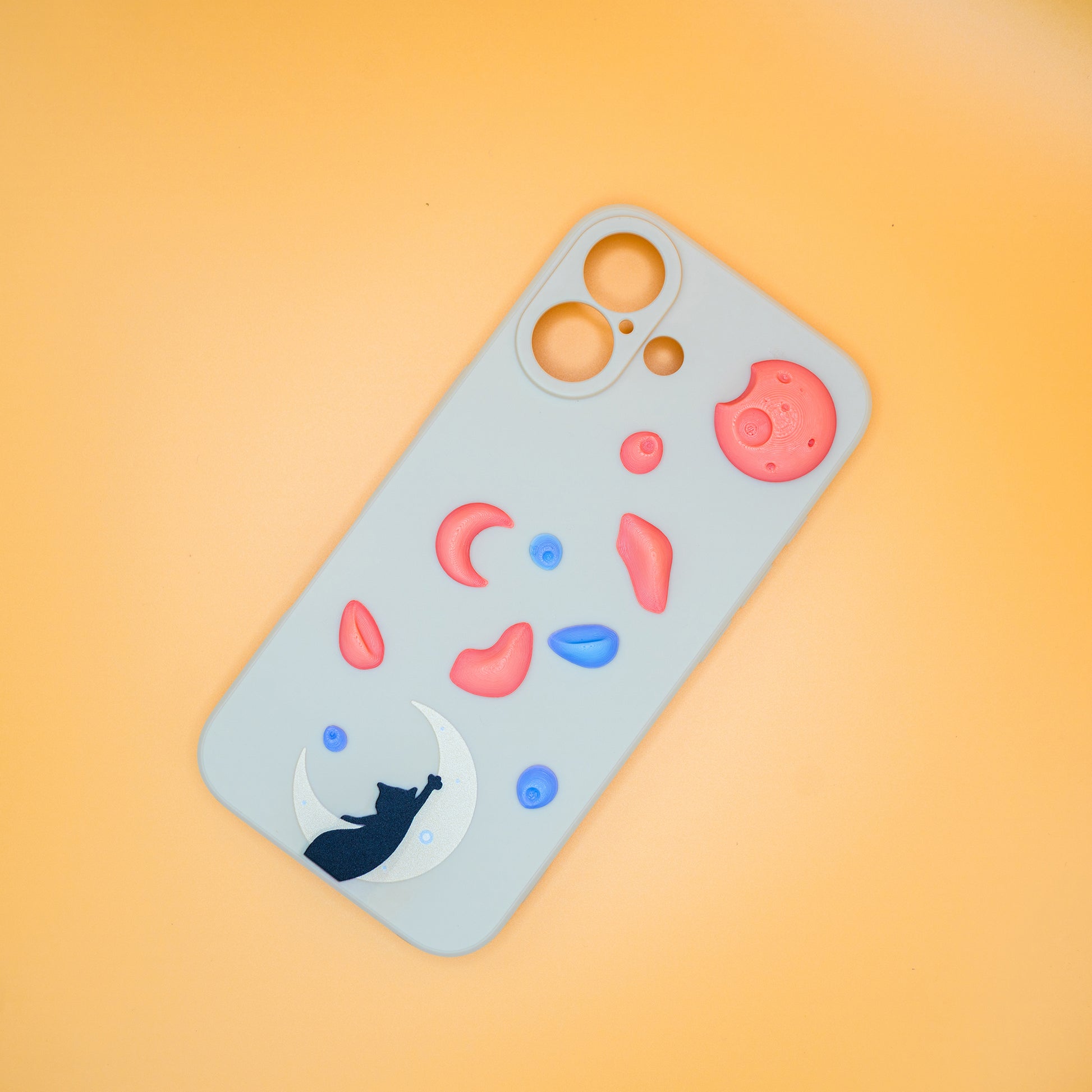 A black cat reaching up from a moon toward floating climbing holds – printed on a playful iPhone case, designed by Non Vertical Lab. A fun and thoughtful gift for climbers, cat lovers, and anyone who needs a little extra grip in life.