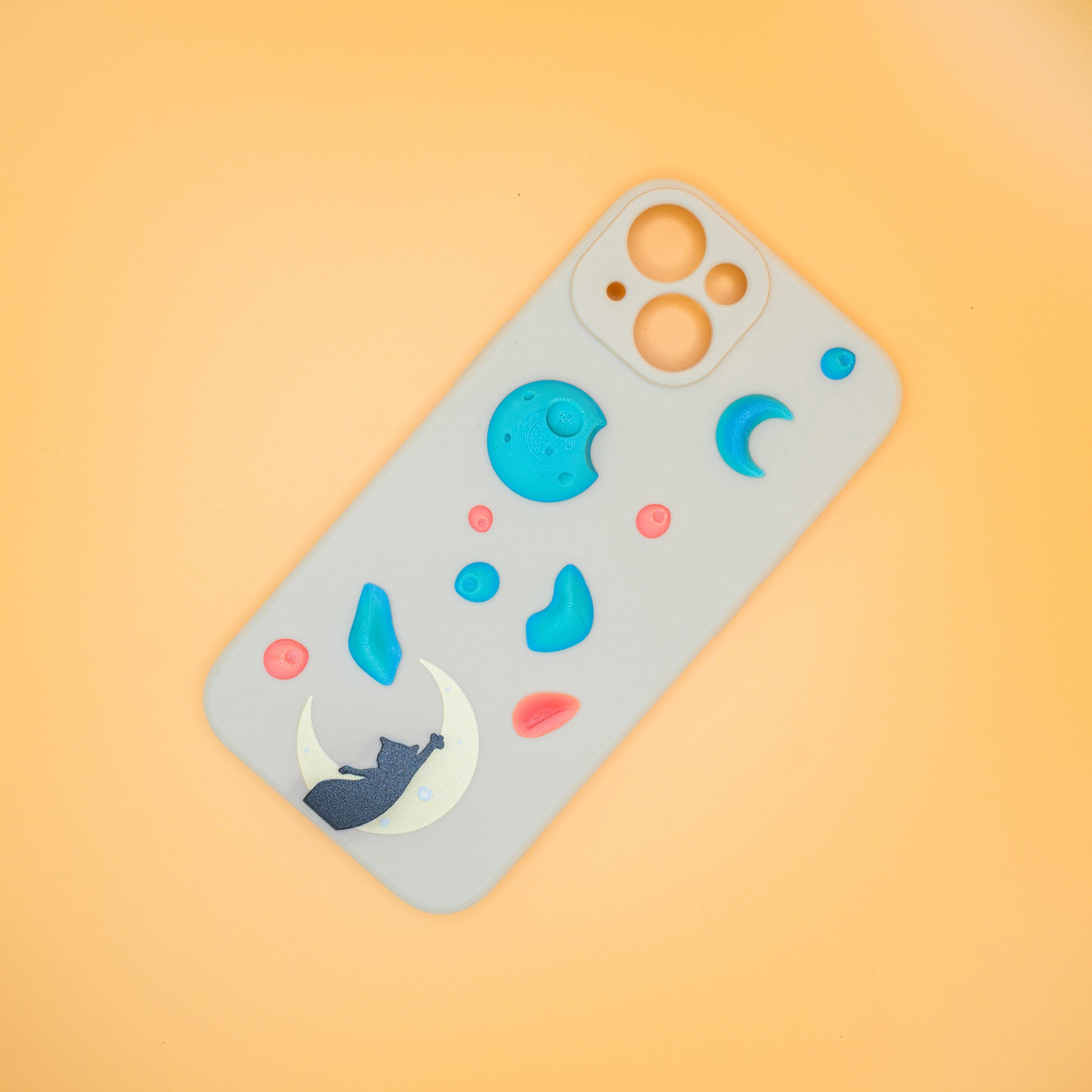 A black cat reaching up from a moon toward floating climbing holds – printed on a playful iPhone case, designed by Non Vertical Lab. A fun and thoughtful gift for climbers, cat lovers, and anyone who needs a little extra grip in life.