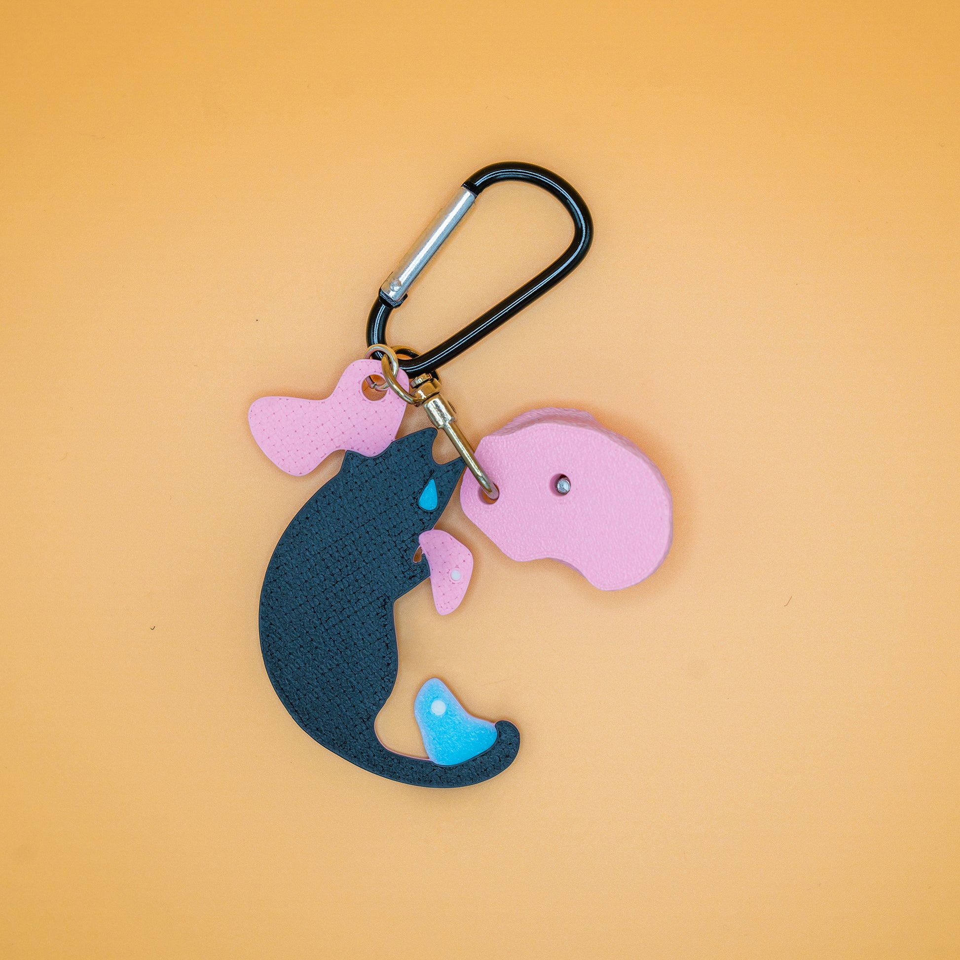 A funny short-armed cat keychain – a relatable and charming gift for climbers who know the struggle of bad reach. Designed by Non Vertical Lab.